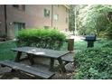 View of the community picnic area with wooden picnic table and chairs at 1131 Clairemont Ave # B, Decatur, GA 30030