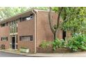 Two-story brick condo with large windows, black shutters, and small front garden at 1131 Clairemont Ave # B, Decatur, GA 30030