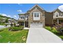 Charming two-story home with brick and siding exterior, well-manicured lawn and an attached two car garage at 2300 Ivy Birch Ln, Buford, GA 30519