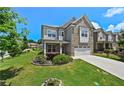 Charming two-story home with brick and siding exterior, well-manicured lawn and an attached two car garage at 2300 Ivy Birch Ln, Buford, GA 30519