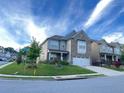 Charming two-story home with a well-manicured lawn and a two-car garage at 2300 Ivy Birch Ln, Buford, GA 30519