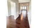Elegant hallway with hardwood floors and decorative trim, leading to a bright living area at 2300 Ivy Birch Ln, Buford, GA 30519
