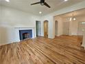 Spacious living room with beautiful hardwood floors and a decorative fireplace with white mantel at 1497 Elizabeth Ln, East Point, GA 30344