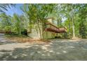 A view of the back of the house featuring a two-story deck and a ground-level garage at 3957 Woodland Cir, Conyers, GA 30013