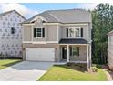 Charming two-story home with brick accents, a two-car garage, and a covered front porch at 419 Crestmont Ln, Canton, GA 30114