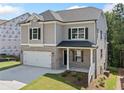 Charming two-story home featuring brick and siding, a two-car garage, and manicured landscaping at 419 Crestmont Ln, Canton, GA 30114
