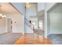 Bright and airy foyer with hardwood floors, a staircase, and neutral decor leading into adjacent rooms at 5025 Bishops Row Row, Austell, GA 30106