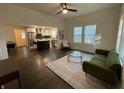 Open-concept living room with hardwood floors, stylish furnishings, and seamless access to the kitchen at 535 Walnut St, Hapeville, GA 30354