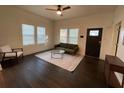 Bright living room with hardwood floors, large windows, ceiling fan, and comfortable seating at 535 Walnut St, Hapeville, GA 30354
