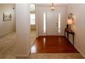 Inviting foyer with hardwood floors, adjacent to a carpeted room and featuring a hall table at 555 Flintlock Dr, Dacula, GA 30019