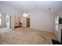 Bright living room with vaulted ceilings, a ceiling fan, and neutral carpeting at 555 Flintlock Dr, Dacula, GA 30019