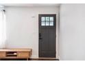The entryway features a modern paneled door, and white walls at 205 Maple St, Atlanta, GA 30354
