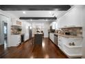 Bright kitchen boasts white cabinets, granite countertops, stainless appliances, and a center island at 1045 Moreland Se Ave, Atlanta, GA 30316