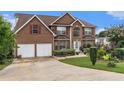 Well-maintained brick home with a two-car garage and an inviting, spacious driveway at 11961 Markham Way, Hampton, GA 30228