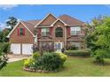 Attractive brick home boasting a beautifully landscaped front yard and red window shutters at 11961 Markham Way, Hampton, GA 30228