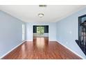 Bright living room featuring hardwood floors, light blue walls, and an open layout at 1553 Smithson Ct, Lithonia, GA 30058