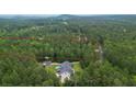 Aerial view of a home on a lot, marked with red boundaries, surrounded by dense woods at 188 A Macedonia Rd, White, GA 30184