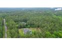 Lush, green aerial view of a home and acreage surrounded by dense trees and a winding road at 188 A Macedonia Rd, White, GA 30184