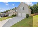 Street view of a well-kept home with a long driveway and green lawn at 4420 Ambassador Way, Cumming, GA 30040