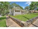 Charming bungalow with a front porch and lovely landscaping at 1667 Sylvan Sw Rd, Atlanta, GA 30310