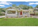 Charming bungalow with a front porch and well-manicured lawn at 1667 Sylvan Sw Rd, Atlanta, GA 30310