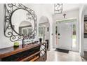 Inviting foyer with tiled floors, arched doorways, and a decorative mirror creating an elegant entrance at 3003 Hanover Se Ln, Conyers, GA 30094
