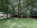 Suburban home with large trees and a sprawling green lawn at 390 Hunt River Way, Suwanee, GA 30024