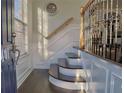 Elegant entryway featuring hardwood floors, staircase with wrought iron railing, and natural light at 401 Iona Abbey Ct # 6, Smyrna, GA 30082