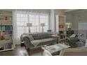 Comfortable living room showcasing a tufted couch, built-in bookshelves, and plenty of natural light at 401 Iona Abbey Ct # 6, Smyrna, GA 30082
