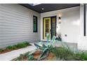 Charming front entry with bright, welcoming door, manicured landscaping, and modern accents at 23 Walthall Ne St, Atlanta, GA 30317