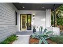 Inviting front entrance with a unique front door, tasteful landscaping, and stylish exterior lighting at 23 Walthall Ne St, Atlanta, GA 30317