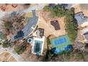 This aerial view showcases the community's pool, tennis court, playground, and parking area at 9122 Golfview Cir, Covington, GA 30014