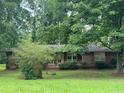 Traditional brick home with a mature tree in the front yard providing shade and curb appeal at 4485 Canary Ct, Lithia Springs, GA 30122