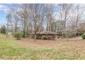 Charming brick home featuring mature trees and a well-maintained lawn at 4485 Canary Ct, Lithia Springs, GA 30122