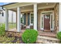 Inviting front porch with stone accents and a cozy seating arrangement at 6470 Long Island Nw Dr, Atlanta, GA 30328