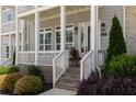 Inviting front porch with brick steps, fresh landscaping and a flower pot at 2125 Parkside Ln, Roswell, GA 30076
