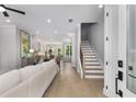 Bright living room with wood floors, open stairs and views into dining and kitchen at 2125 Parkside Ln, Roswell, GA 30076