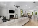Bright living room with a fireplace, TV and adjacent dining area at 2125 Parkside Ln, Roswell, GA 30076