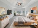 Staged main bedroom with a ceiling fan, sitting area, and stylish decor at 622 Madison Park Dr, Grayson, GA 30017