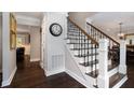 Elegant entryway with hardwood floors, staircase with iron railings, and decorative accents at 1379 Cambridge Ne Ct, Brookhaven, GA 30319