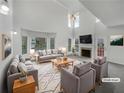 Bright living room with high ceilings, fireplace, and lots of natural light at 2231 Mill Garden Pl, Buford, GA 30519