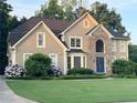 Charming two-story home boasting stone accents, a manicured lawn, and mature trees at 5807 Brookstone Nw Walk, Acworth, GA 30101