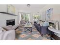 Bright living room featuring a decorative fireplace, modern furniture, and artistic accents at 2135 Huntington Dr, Loganville, GA 30052