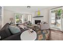 Cozy living room with a fireplace, large windows, and stylish decor at 2135 Huntington Dr, Loganville, GA 30052