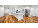 Modern kitchen boasts white cabinets, stainless steel appliances, and a quartz island at 2798 Hutchins Rd, Lawrenceville, GA 30044