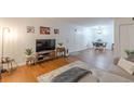 Living room with an open layout, hardwood floors, a gray sofa, and access to the dining area at 3135 Seven Pines Ct # 201, Atlanta, GA 30339
