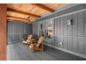 Inviting covered porch with stylish chairs and wood paneled ceiling at 10775 Shallowford Rd, Roswell, GA 30075