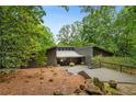 Attractive single-story home with unique modern design and surrounded by mature trees at 10775 Shallowford Rd, Roswell, GA 30075