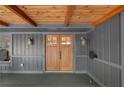 Close up on craftsman style double doors and covered porch with wood ceiling at 10775 Shallowford Rd, Roswell, GA 30075