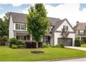 Charming two-story home with a well-maintained lawn, mature trees, and a two-car garage, set in a peaceful neighborhood at 374 Heritage, Woodstock, GA 30188